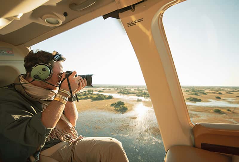 Photographer in helicopter over Okavango Delta